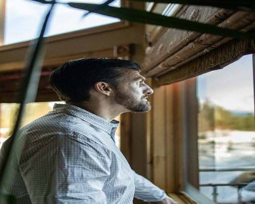 Person looking out of a window thoughtfully