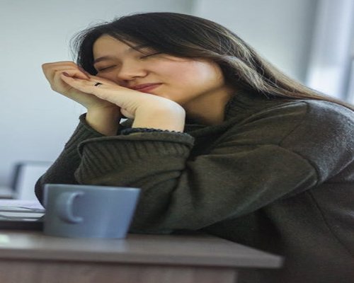 Person resting eyes while sitting at a desk